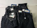 three pairs of men ' s black pants with tags on them