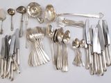 beaucoup de cuillères et de couteaux en argent sur la table