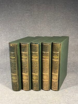 four green books sitting on top of each other on a table