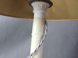 a lamp that is on a metal pole with a rope