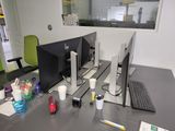 a desk with two computer monitors and a keyboard on it