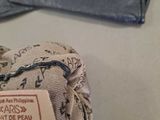 a person holding a glove that has a tag on it