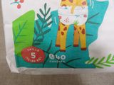a giraffe that is wearing a diaper on a bag