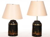 pair of black and gold table lamps with lampshads on each of them
