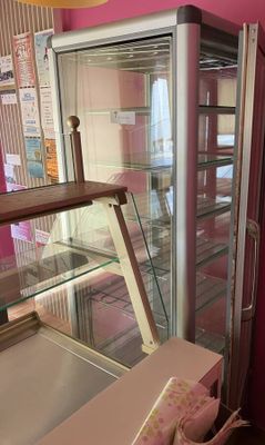 a glass display case with donuts inside of it