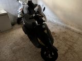 a motorcycle that is parked in the corner of a room