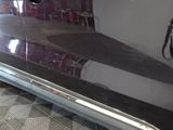 a picture of a black car with chrome trims in a garage