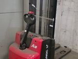 a red fork lift truck parked in a garage