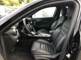 the interior of a car with a black leather seat and steering wheel