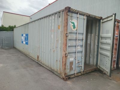 a large container sitting in the middle of a parking lot