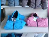 several jackets on display in a store with price tags on them