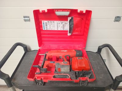 a red tool box with tools in it sitting on a cart