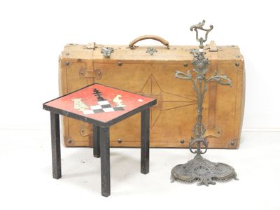a small table with a chess board on it next to a piece of luggage