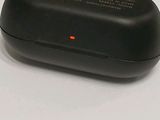 an image of a black mouse with a red dot on it