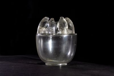 a glass cup with ice inside of it on a table
