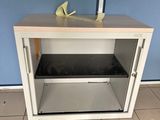 a small cabinet with a shoe on top of it