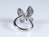 a close up of a silver ring with a butterfly on it