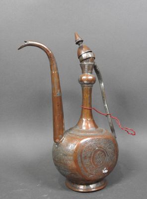 a silver and copper teapot with a red handle