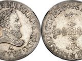 a silver coin with an image of a man ' s head on it