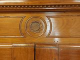 a close up of a wooden cabinet with a clock on top of it