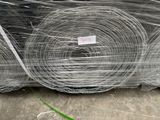 many rolls of wire wrapped in plastic on the ground