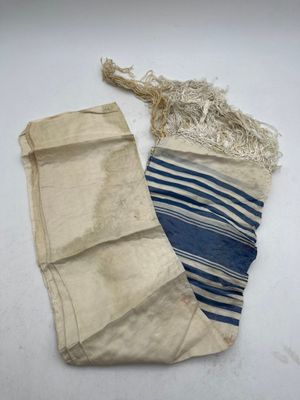 a pair of blue and white striped bags sitting on top of a white table