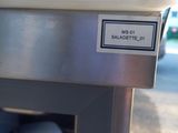a close up of a parking meter with a sign on it