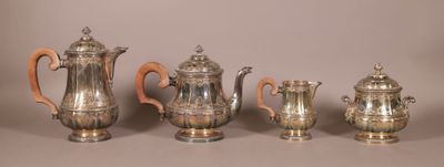five pieces of silver tea and coffee set on a table
