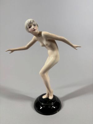 a figurine of a woman that is standing on a black base