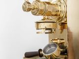 a gold coffee machine sitting on top of a table