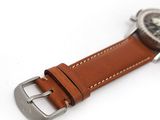 the brown strap is attached to a watch with a silver buckle