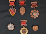 several medals and medals are displayed on a black surface