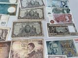 several different bank notes are laid out on a table