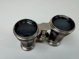an old pair of binoculars sitting on top of a white table