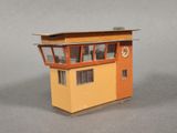 a small model of a building with a clock on it