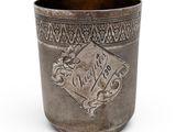 a silver cup with a design on the side of it