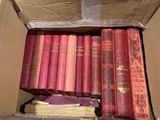 a box full of old books sitting on a table