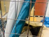 a cage that has a blue and white blanket in it