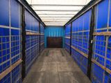 a long hallway with blue walls and wooden flooring