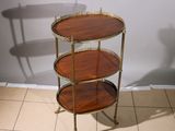 a three tiered table that is on a tile floor