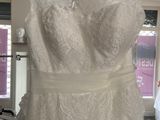 a wedding dress on a hanger in a bridal shop