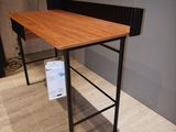 a table with a wooden top and metal legs