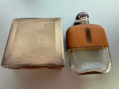 a bottle of perfume sitting next to a box on a table