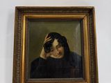 portrait of a man in a black coat holding his head in his hands