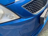 a close up of the front of a blue car