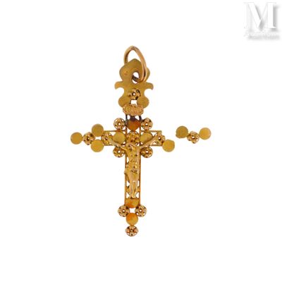 une image représentant une croix en or surmontée d'une fleur