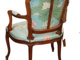 a wooden chair with a blue and green upholstered seat