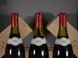 three bottles of wine are sitting in a wooden box