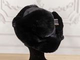 a black hat that is on top of a wooden table