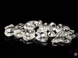 a close up of a bunch of diamonds on a black surface